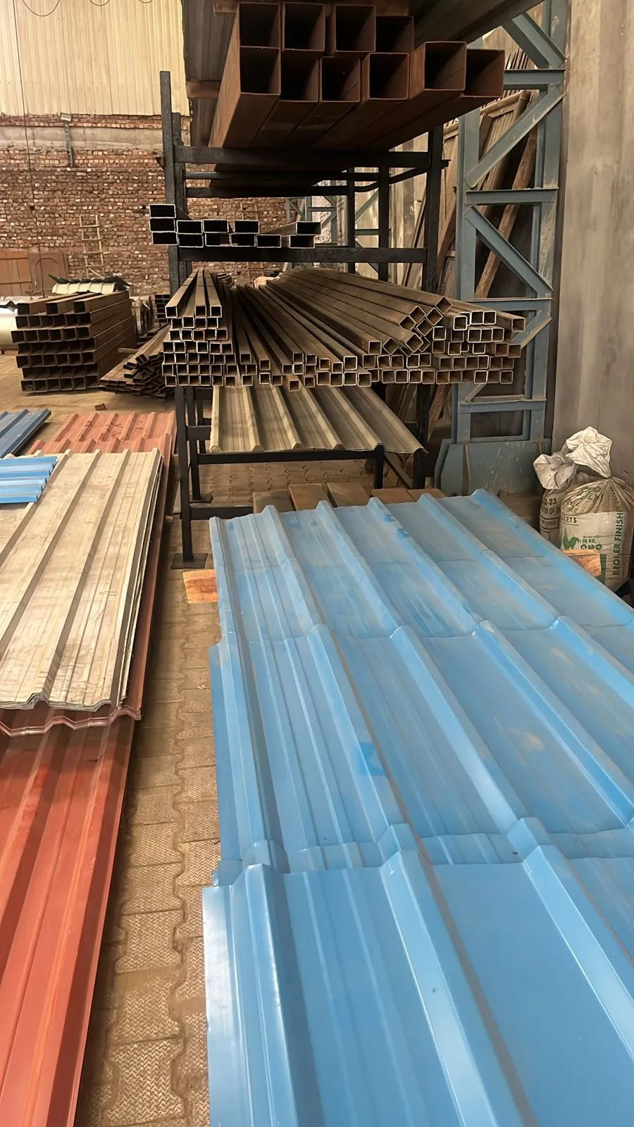 Apex Metals Facility: Ready-to-Ship Stock - Vast inventory of customized color coated sheets.